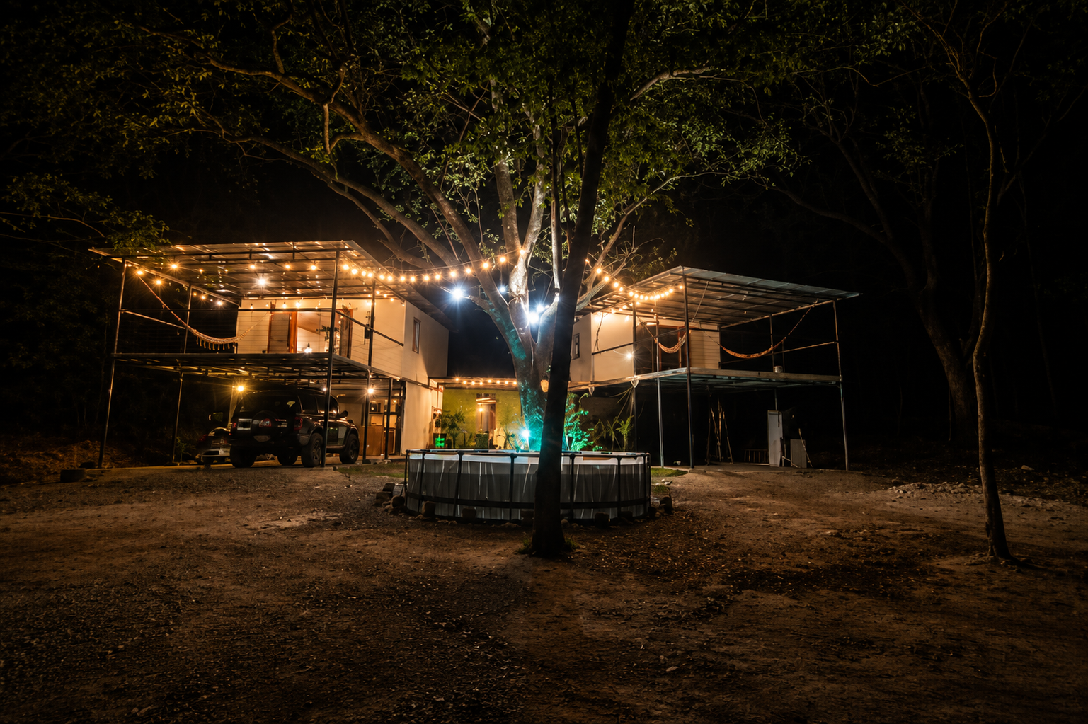 Chango's Jungle House glowing with string lights at night in the Costa Rica jungle