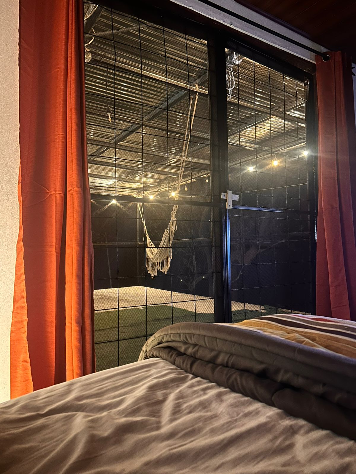 Private balcony view with hammock at night